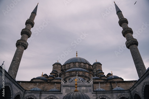 Photography Yeni Valide Camii Mosque or New Mosque of Istanbul with a large dome and tall mi