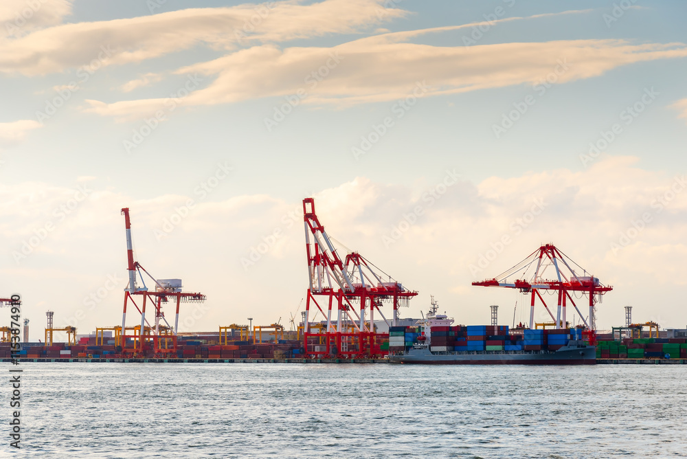 Container port and container crane at Industrial port for cargo container ship Osaka Japan. Business logistic transportation concept. Container port and container crane at Industrial port for cargo container ship Osaka Japan. Business logistic transportation concept.