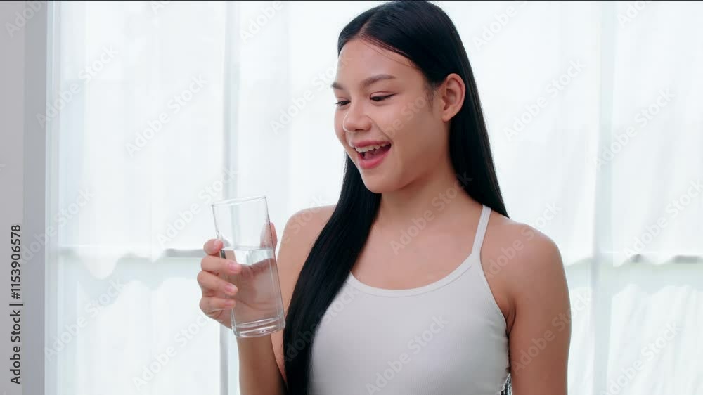 Teenage girl happily drinking water after yoga exercise Teenage girl happily drinking water after yoga exercise