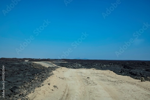 Road through the remote volcanic landscape of the Afar region in Ethiopia photo