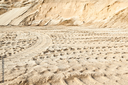 Excavator wheel marks in a sand quarry