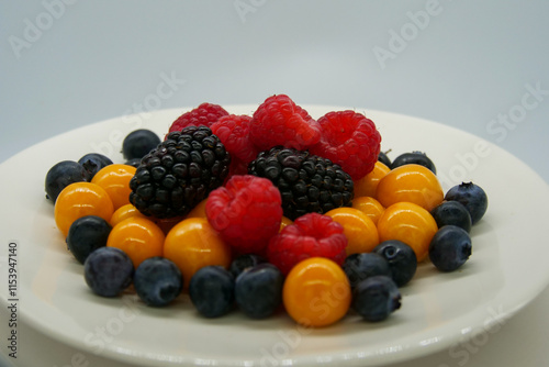 Wallpaper Mural Brightly colored fresh berries on a white plate in front of a white background Torontodigital.ca