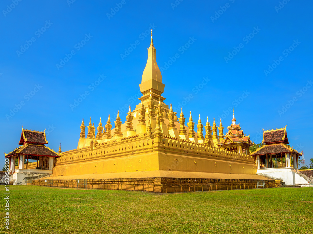 Naklejka premium Pha That Luang is a large, gold-covered Buddhist stupa in the centre of the city of Vientiane, capital of Laos.