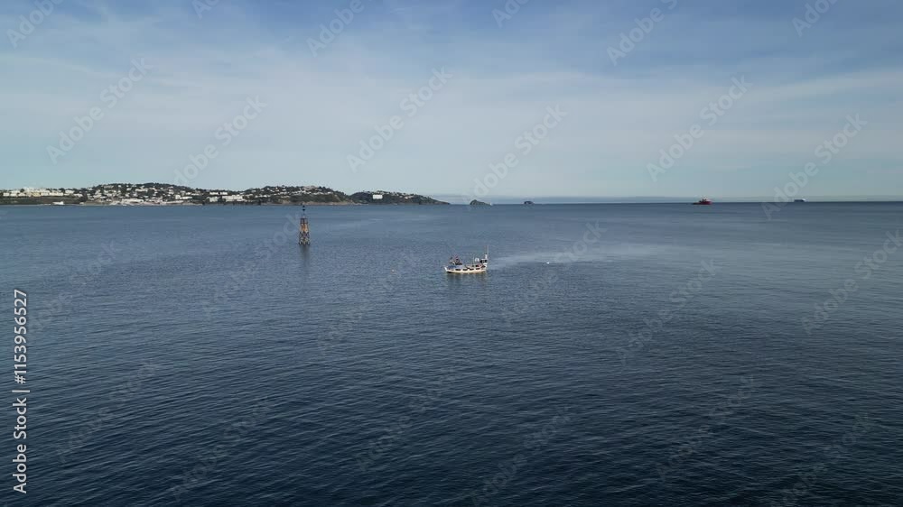 Paignton, Torbay, South Devon, England: DRONE VIEWS: A fishing boat works just off Paignton harbour as it picks up fish from submerged pots. Local restaurants support the fish trade (Clip 3). Paignton, Torbay, South Devon, England: DRONE VIEWS: A fishing boat works just off Paignton harbour as it picks up fish from submerged pots. Local restaurants support the fish trade (Clip 3).