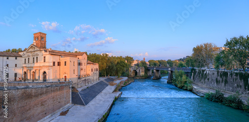 Rome cityscape: glimpse of Tiber Island on the Tiber River at sunset.