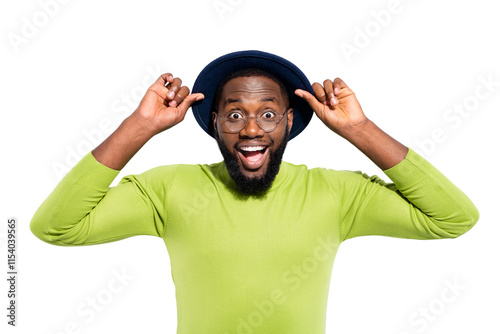 Portrait of impressed funny guy touching his hat screaming wearing green sweater isolated over white background photo