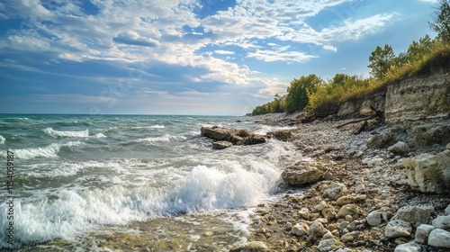 Waves crashing on rocky shore under cloudy sky with lush trees nearby capturing the essence of nature's rugged beauty