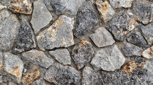 Granite stone wall texture with rough grey and black jagged stones for construction and architectural design backgrounds