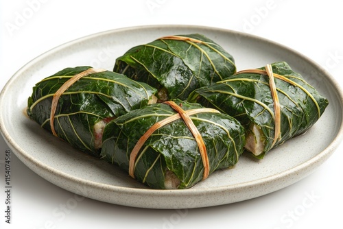 hawaiian cuisine, hawaiian lau lau in ti leaves on a white plate, set against a white backdrop photo