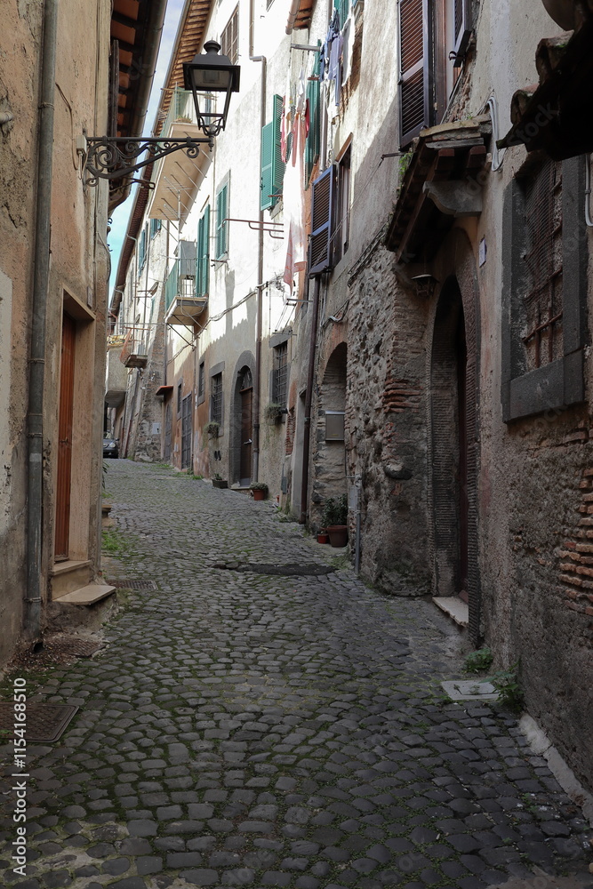Fototapeta premium View of narrow medieval street with ancient buildings in Bracciano, Italy.