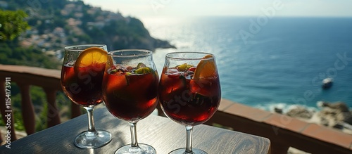 Refreshing sangria cocktails overlooking a stunning coastal view during a sunny day photo