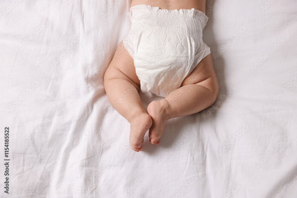 Cute little baby in diaper on bed, top view Cute little baby in diaper on bed, top view