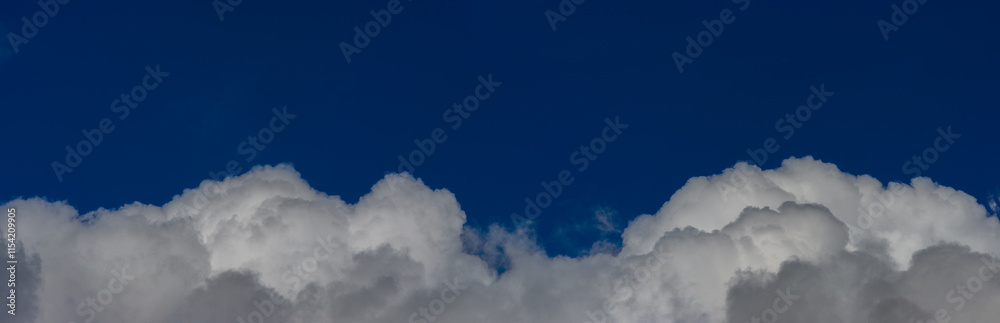 White cumulus clouds on a sunny day in the blue sky. Web banner. White cumulus clouds on a sunny day in the blue sky. Web banner.