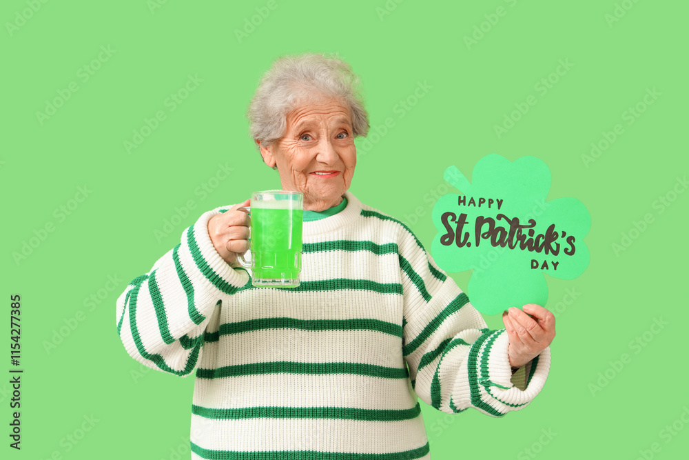 Senior woman with mug of green beer holding festive postcard with text HAPPY ST. PATRICK'S DAY on color background Senior woman with mug of green beer holding festive postcard with text HAPPY ST. PATRICK'S DAY on color background