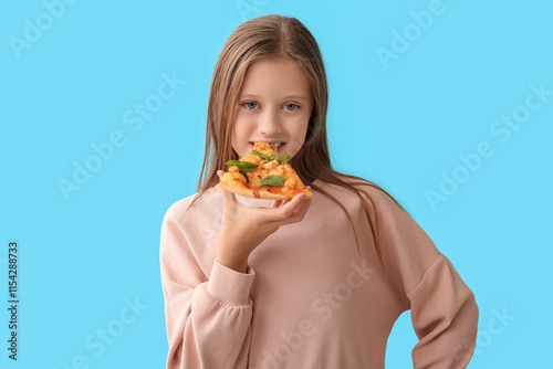 Cute little happy girl eati...