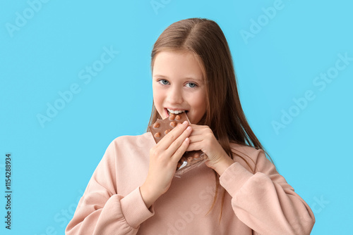 Cute little happy girl eati...