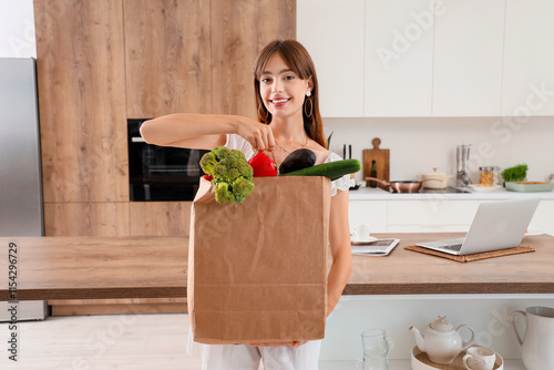 Young woman with paper bag ...