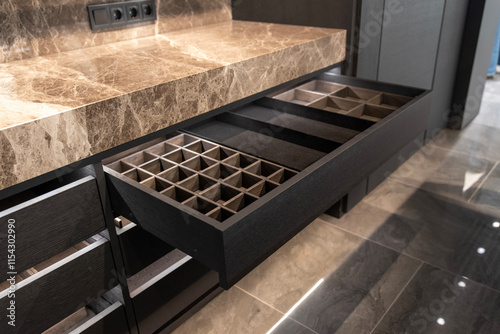 Photography Wooden drawer with organized compartments in a modern kitchen