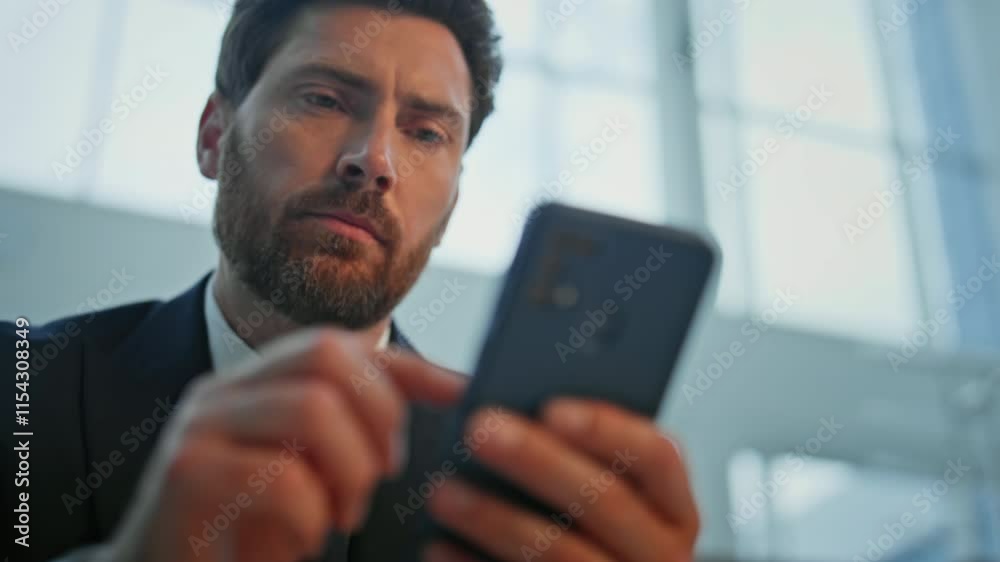 Businessman hands scrolling smartphone at light building interior closeup. 