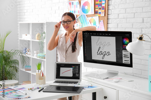 Female Asian graphic designer at workplace in office photo