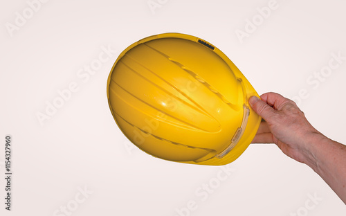 Obraz na płótnie Construction worker holding a yellow safety helmet w salonie