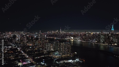 Wallpaper Mural Views of the East River reveal New York City's illuminated skyline at night, showcasing vibrant lights and iconic skyscrapers that define the urban landscape of Manhattan Torontodigital.ca