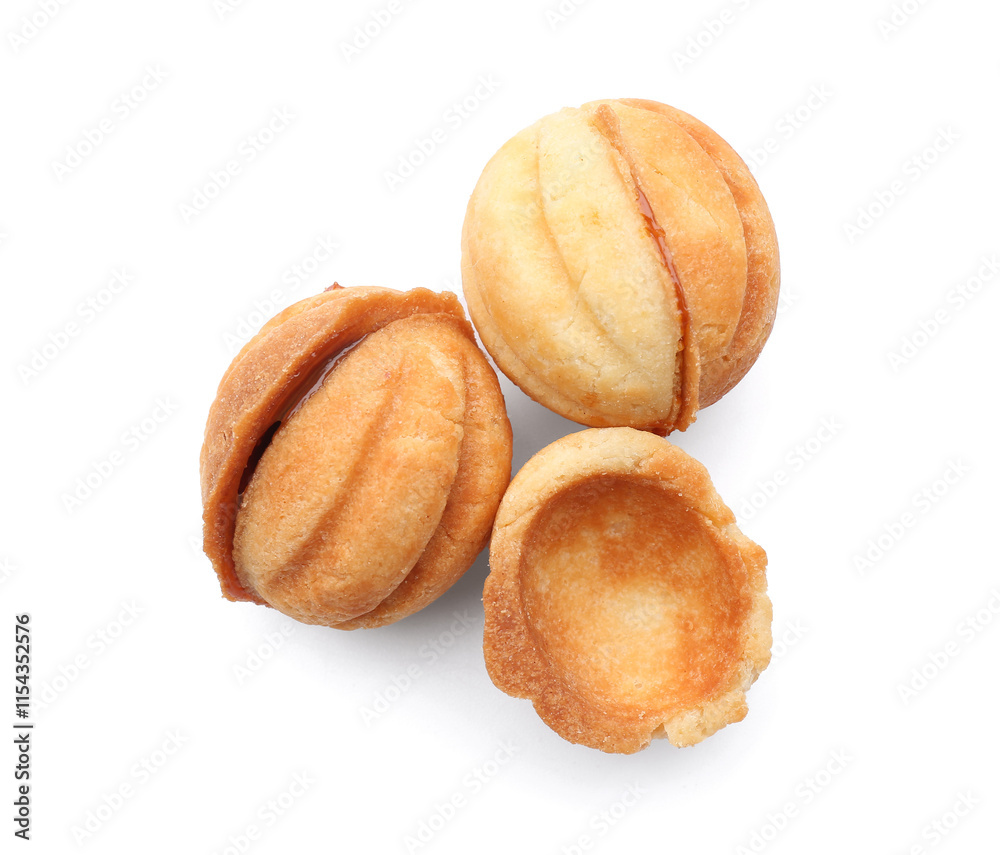Sweet walnut shaped cookies with boiled condensed milk on white background Sweet walnut shaped cookies with boiled condensed milk on white background
