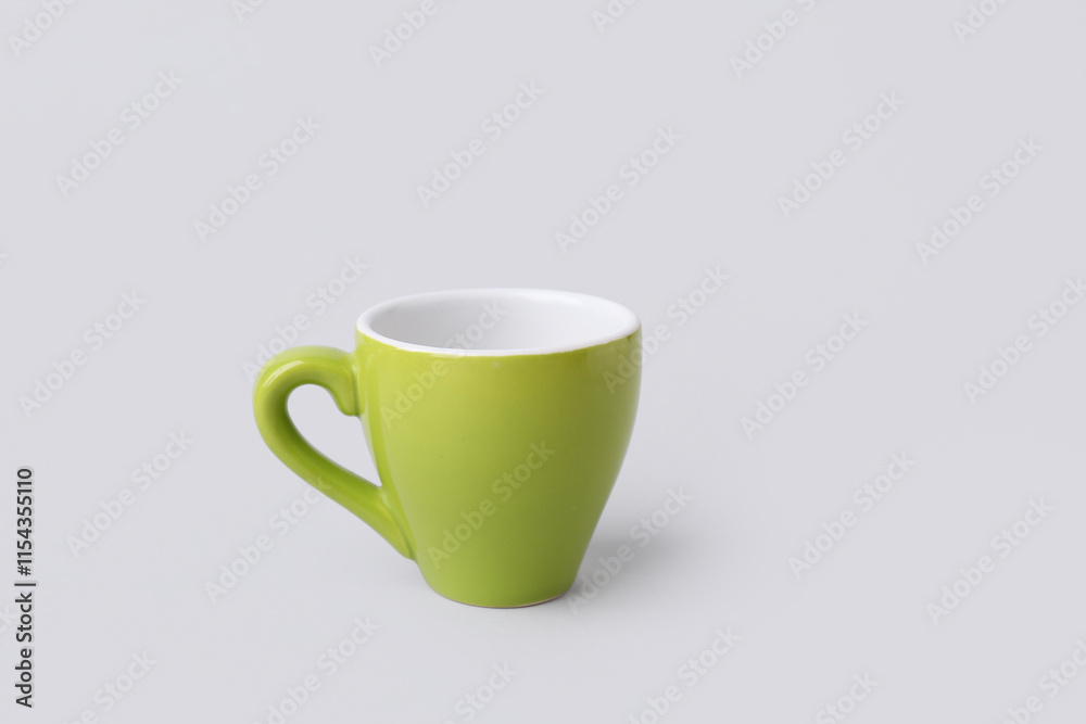 Fototapeta premium Green ceramic cup on grey background