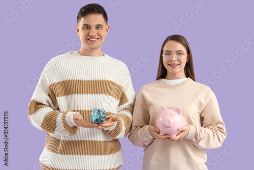 Young couple holding piggy ...