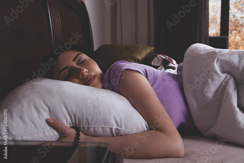 young woman lying on bed with pillow