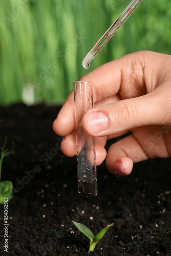 Woman holding test tube wit...
