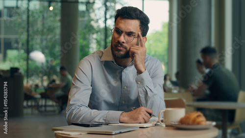 Fotografia Pensive man Indian Arabian businessman male freelancer worker thoughtful student