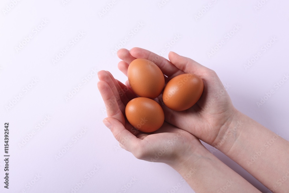Woman with raw eggs on light background, closeup