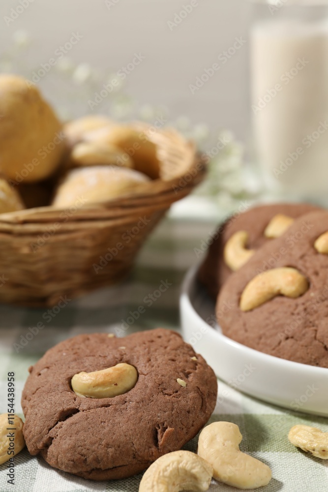 Fototapeta premium Tasty chocolate cookies with cashew on table, closeup