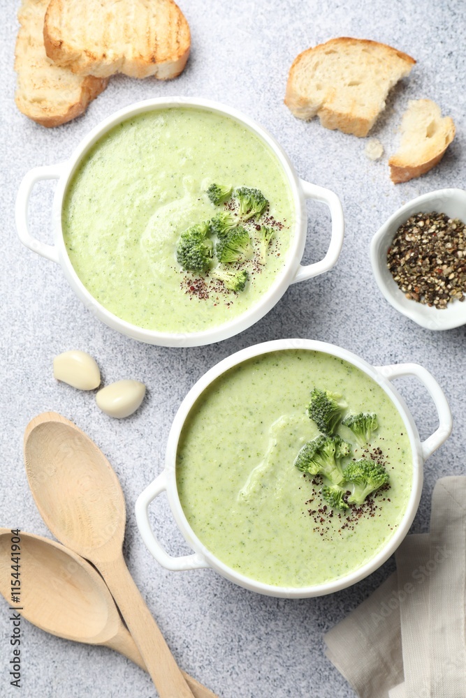 Delicious broccoli cream soup served on light table, flat lay Delicious broccoli cream soup served on light table, flat lay