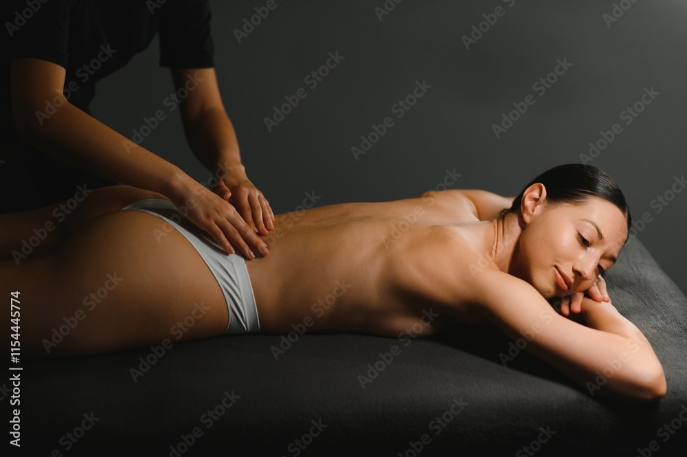 Spa woman. Female enjoying relaxing back massage in cosmetology spa centrer Spa woman. Female enjoying relaxing back massage in cosmetology spa centrer