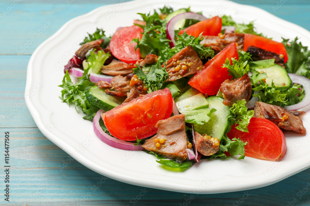 Delicious fresh tuna salad on light blue wooden table, closeup Delicious fresh tuna salad on light blue wooden table, closeup