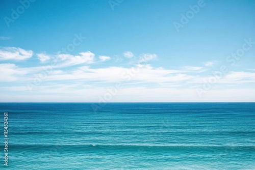A serene ocean view under a clear blue sky, evoking tranquility.