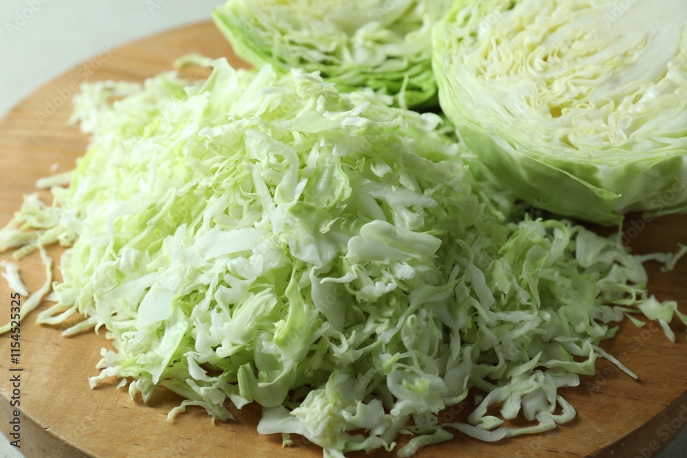 Fresh shredded cabbage on wooden board, closeup Fresh shredded cabbage on wooden board, closeup