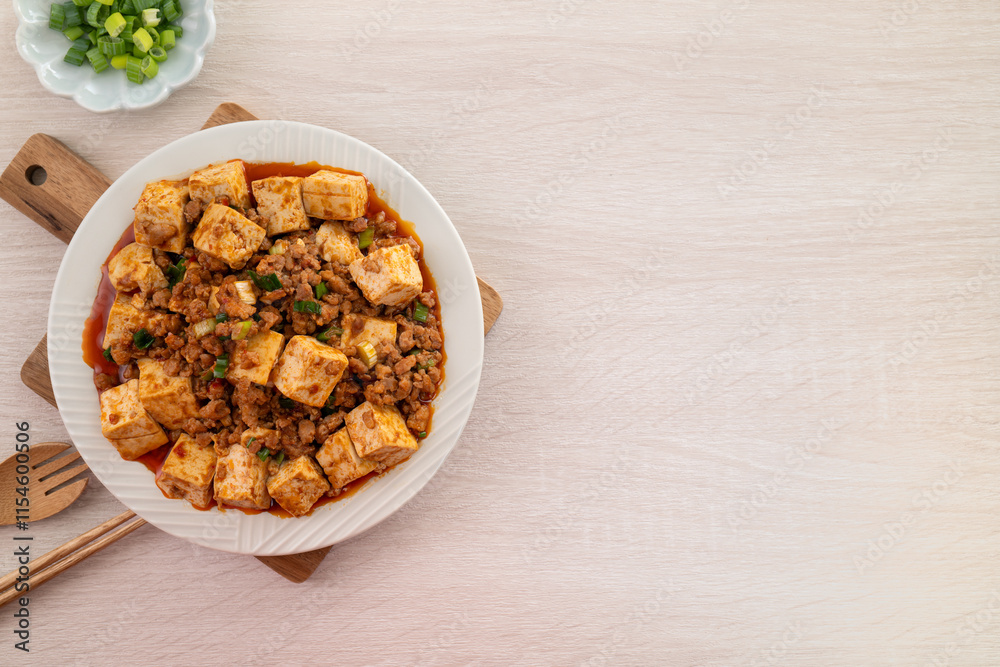 Mapo tofu. Stir-fried tofu with hot spicy sauce in white plate. Mapo tofu. Stir-fried tofu with hot spicy sauce in white plate.