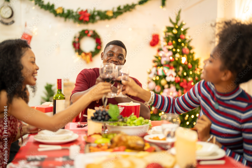 A family enjoys a festive Christmas dinner, sharing food and creating memories. A beautifully decorated Christmas tree and wreath add warmth, while candles and decor enhance the cozy holiday setting.