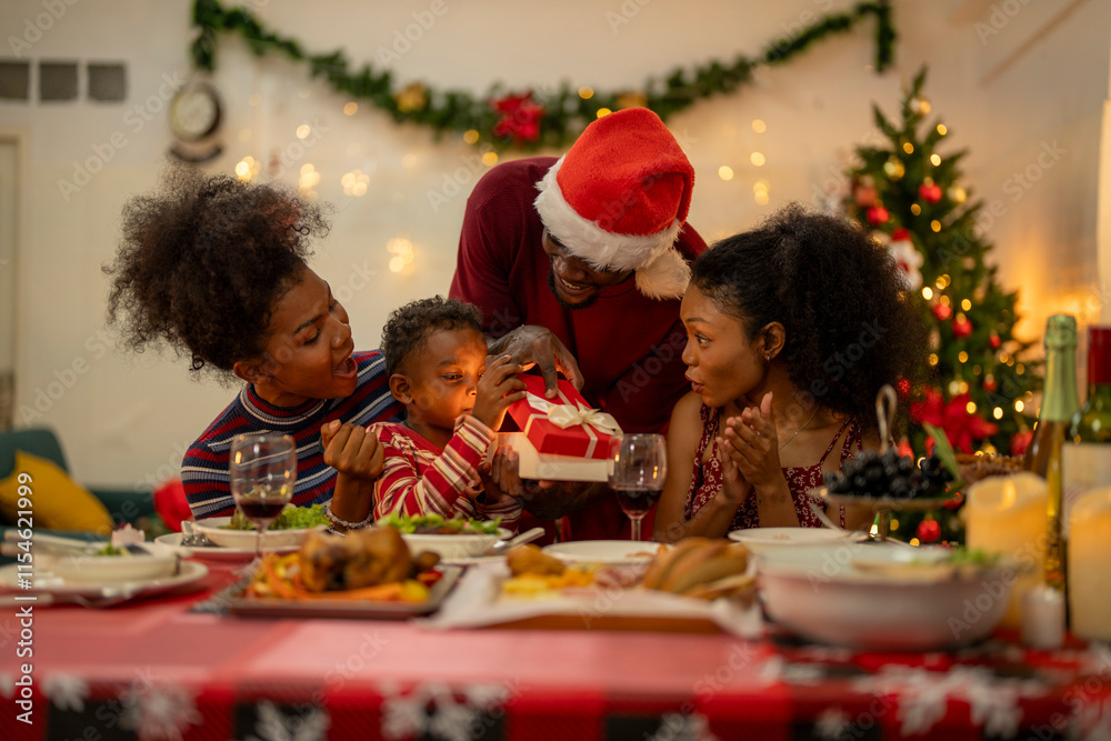 A joyful Christmas celebration with friends gathered around a festive dining table. Featuring a man in a Santa hat, a decorated Christmas tree, delicious food, and warm holiday cheer.