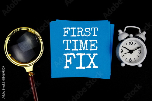 First Time Fix text on sticky note with magnifying glass and alarm clock on black background photo