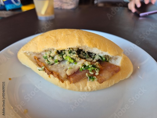 Local baked bread or bun filling with minced pork, sausage and pork serving on the plate. Famous easy breakfast menu in Asia.