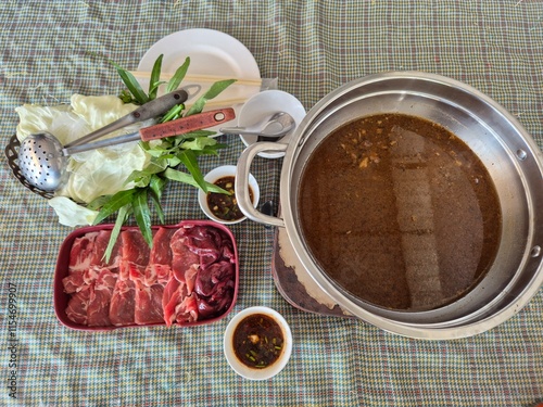 Set of traditional sukiyaki in Thai style. Local hot pot soup with fresh and raw pork set.