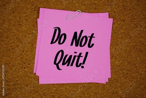 Do Not Quit! text message on stick note on cork paper background photo