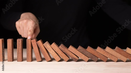 Effective Risk Management Strategies Hand Stopping Falling Dominos in Business Crisis Decision Making with Slow Motion Insights