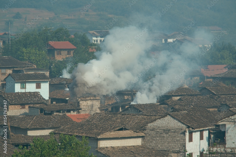 A peaceful evening shot of a Hmong village with smoke rising from the chimneys and the last rays of sunlight casting long shadows A peaceful evening shot of a Hmong village with smoke rising from the chimneys and the last rays of sunlight casting long shadows