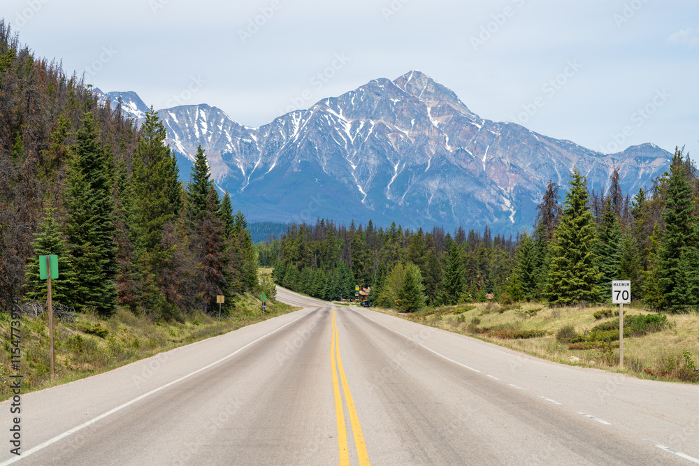 Fototapeta premium Jasper, Alberta, Canada - June 2 2021 : Icefields Parkway (Alberta Highway 93), Jasper National Park. Pyramid Mountain in the background.