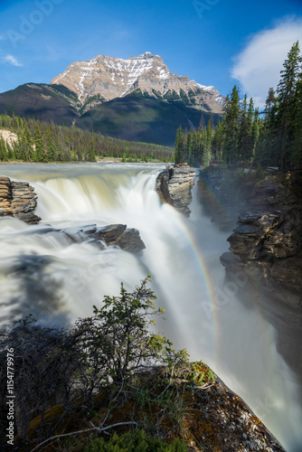 Athabasca Falls with rainbow in Jasper National Park, Alberta, Canada. Canadian Rockies summer landscape. Mount Kerkeslin in the background. photo